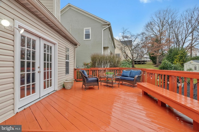 wooden terrace featuring an outdoor hangout area, french doors, and a trampoline