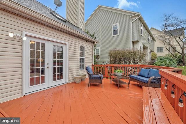 wooden deck featuring french doors and an outdoor living space