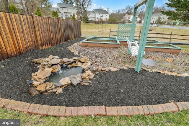 view of yard with a garden and fence