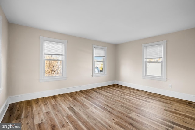 empty room with wood finished floors and baseboards