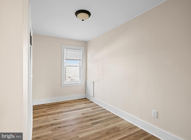 spare room featuring light wood finished floors and baseboards