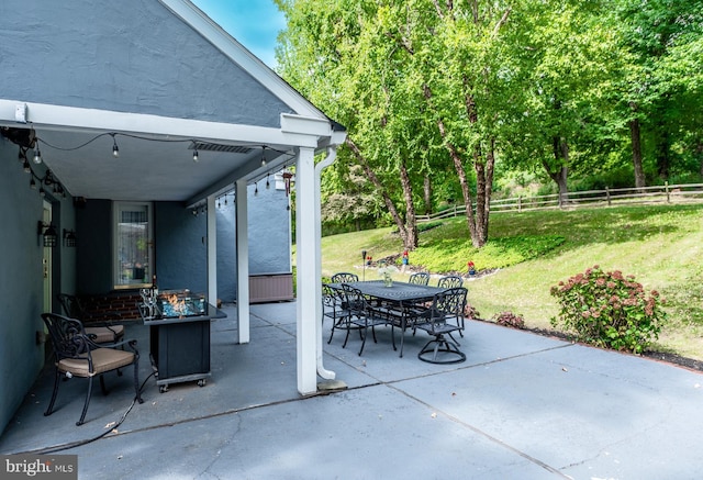 view of patio / terrace with outdoor dining space and fence