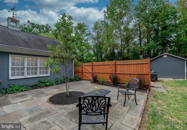 view of patio featuring an outdoor structure and fence