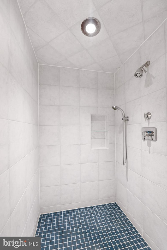 bathroom with tiled shower