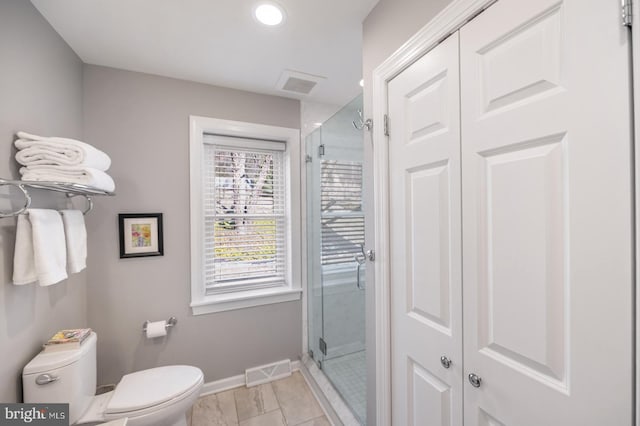 bathroom featuring toilet, visible vents, and a stall shower