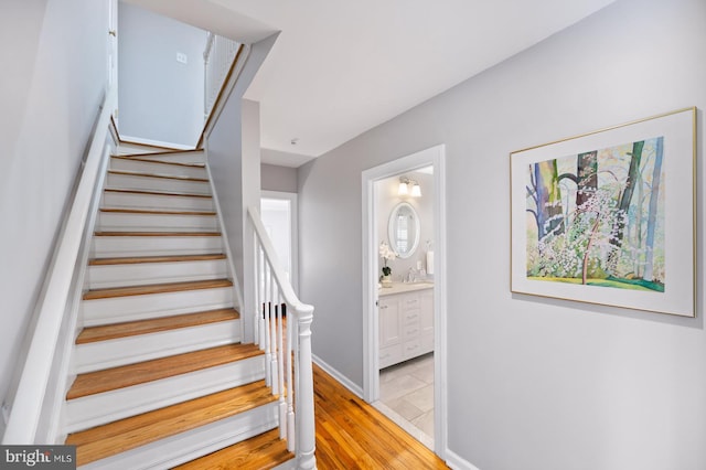 stairs featuring baseboards and wood finished floors