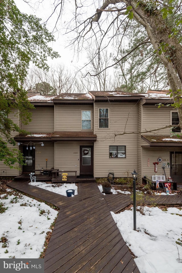 snow covered property featuring a deck