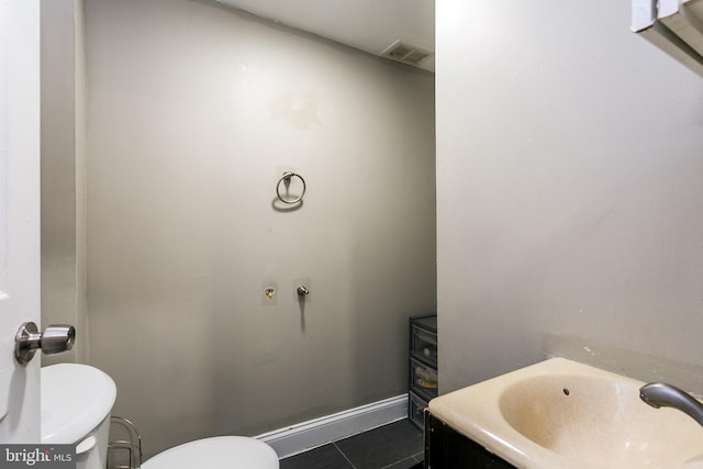 bathroom featuring tile patterned floors, toilet, and vanity