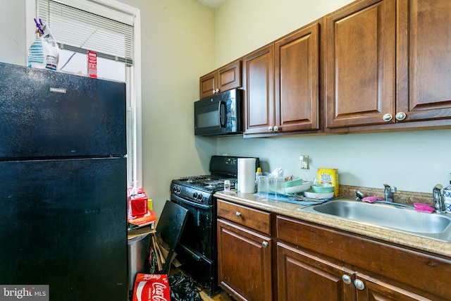 kitchen with sink and black appliances