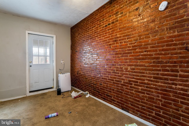 entryway featuring brick wall and carpet floors