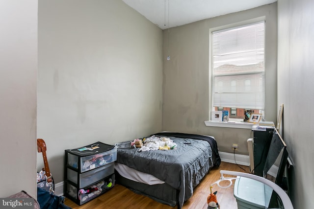 bedroom with hardwood / wood-style floors