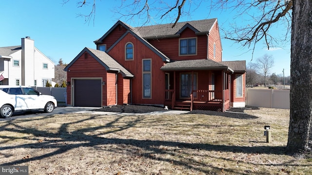 view of front of house with a garage, a front lawn, and a porch