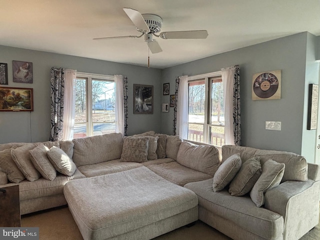 living room featuring plenty of natural light and ceiling fan