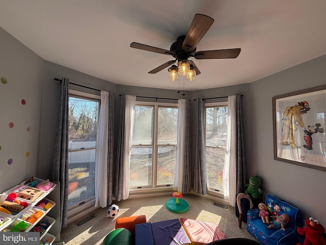 recreation room featuring plenty of natural light and light colored carpet