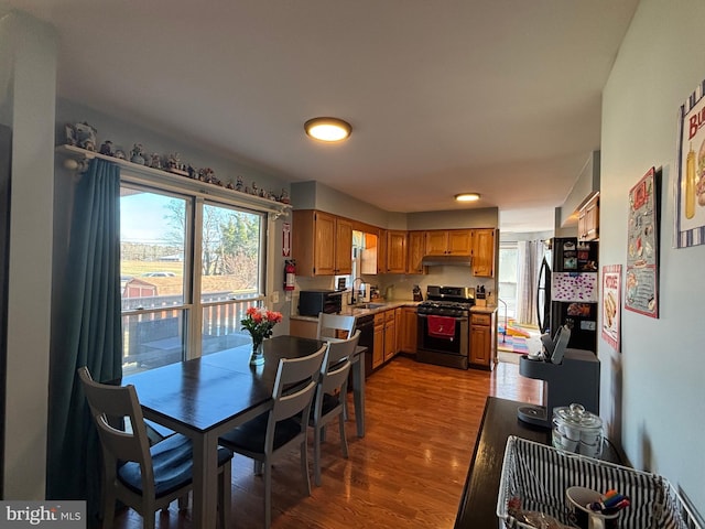 dining space with hardwood / wood-style flooring and sink