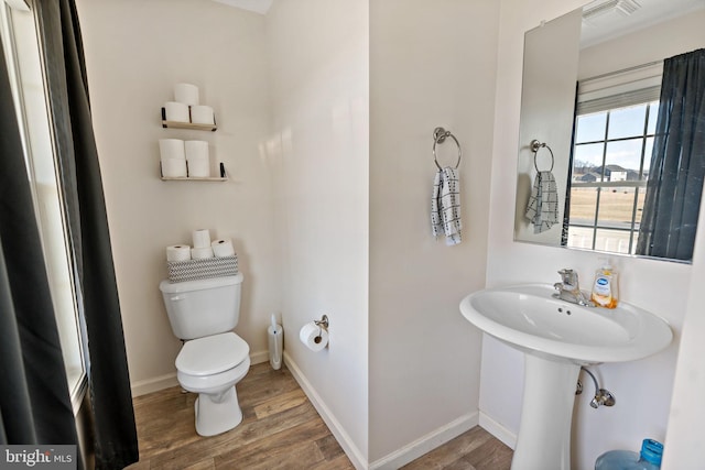 bathroom with toilet and hardwood / wood-style floors