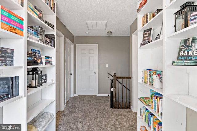 interior space with light colored carpet and a textured ceiling