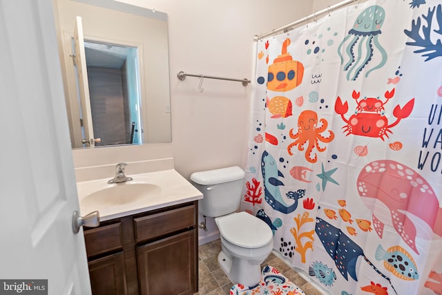 bathroom with toilet, vanity, and a shower with shower curtain