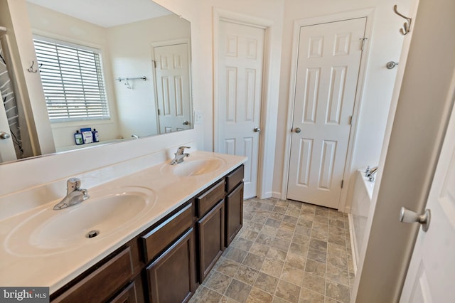 bathroom featuring a tub to relax in and vanity