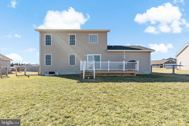 rear view of property with a lawn and a deck