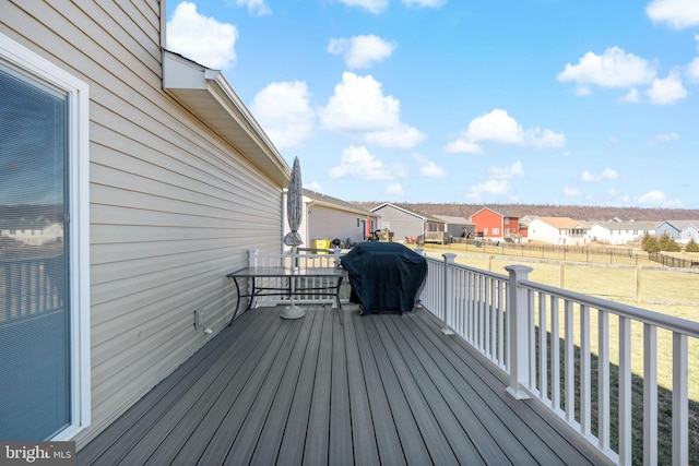 wooden deck featuring a grill