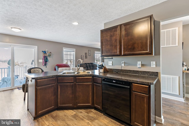 kitchen featuring dark brown cabinets, sink, black dishwasher, and kitchen peninsula