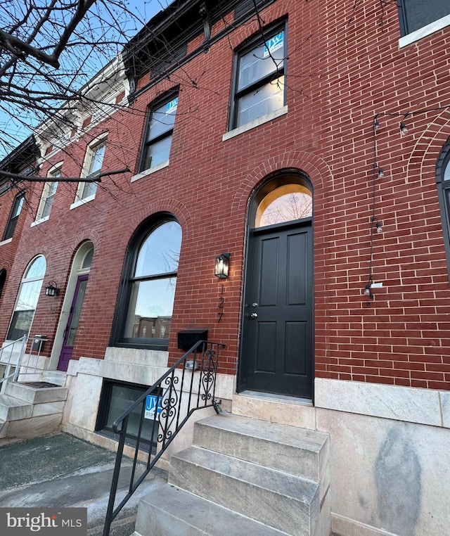 property entrance featuring brick siding