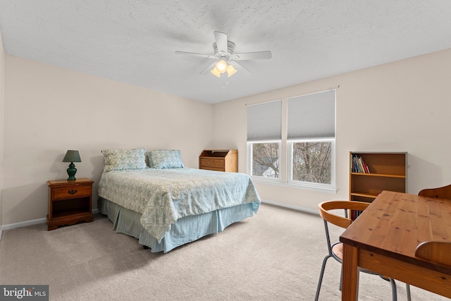 bedroom featuring a textured ceiling, ceiling fan, carpet, and baseboards