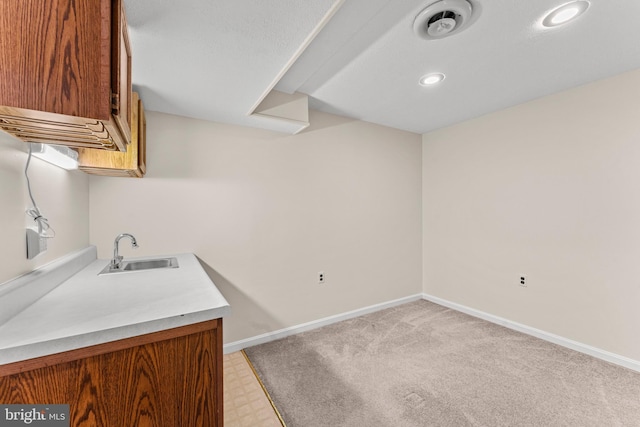 laundry area with recessed lighting, visible vents, a sink, and baseboards