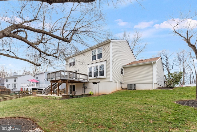 rear view of property featuring central AC unit, a yard, stairway, and a wooden deck