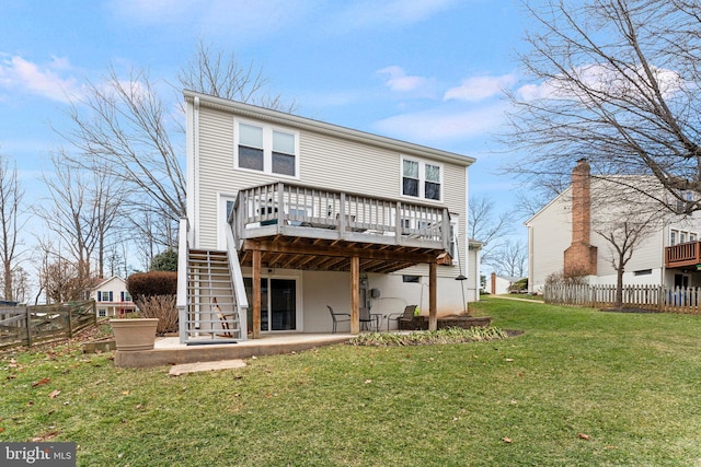 back of house featuring stairway, fence, a deck, a yard, and a patio area