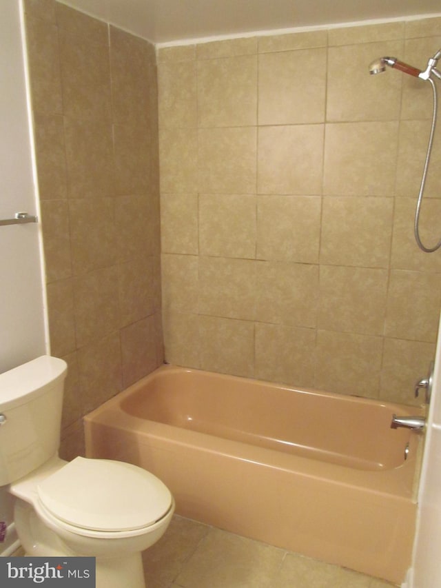 bathroom with tiled shower / bath, tile patterned floors, and toilet