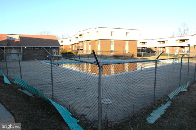 view of swimming pool featuring tennis court