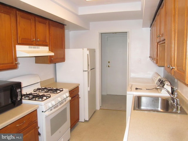 kitchen with sink and white appliances