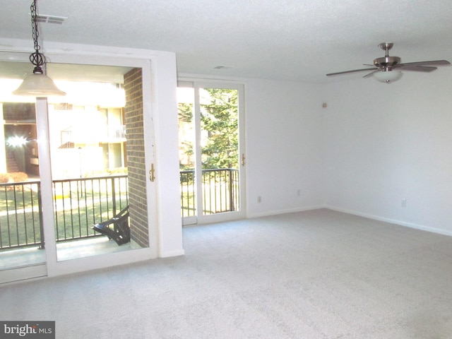 carpeted spare room with ceiling fan