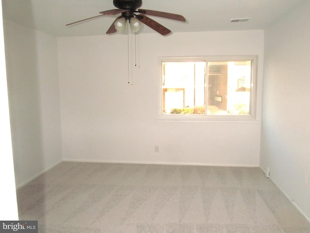 empty room featuring light colored carpet and ceiling fan