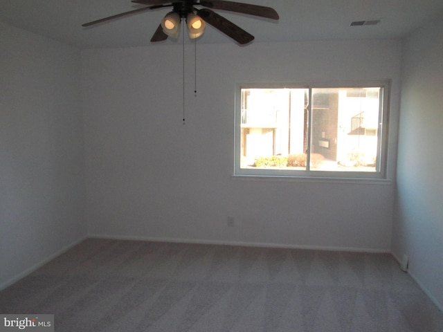 spare room with carpet floors and ceiling fan