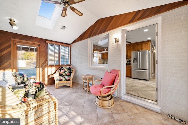 sunroom with lofted ceiling with skylight, visible vents, and a ceiling fan