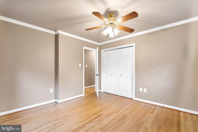 unfurnished bedroom featuring light wood-type flooring, baseboards, and ornamental molding