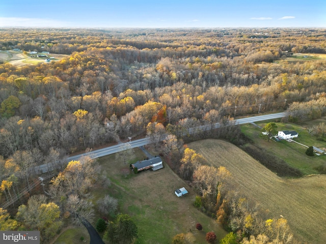 birds eye view of property with a forest view