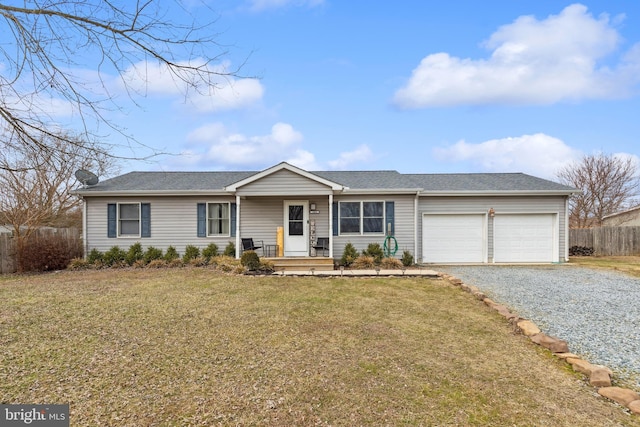 ranch-style home featuring a garage, a front yard, fence, and gravel driveway