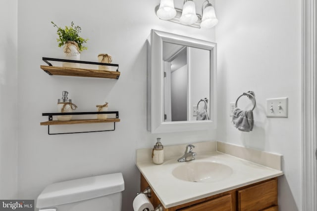 bathroom featuring toilet and vanity