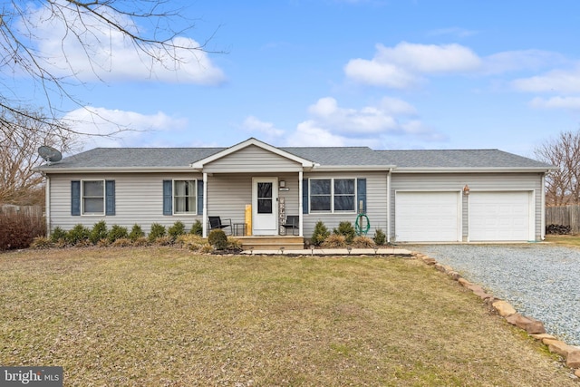 ranch-style house featuring a porch, a front yard, driveway, and an attached garage