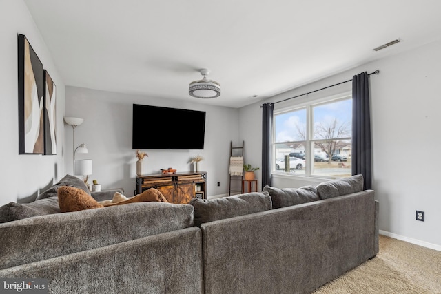 living area featuring light carpet, visible vents, and baseboards