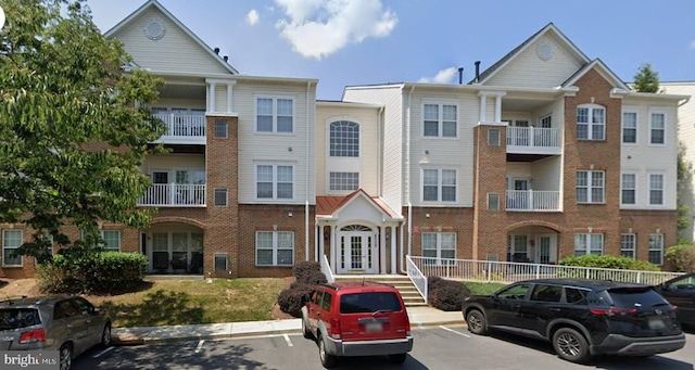 view of building exterior featuring uncovered parking