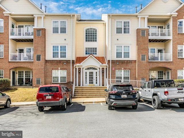 view of building exterior with uncovered parking