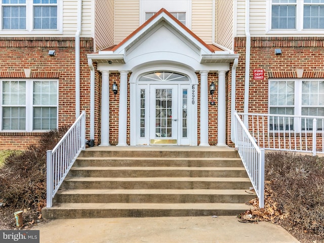 entrance to property featuring brick siding