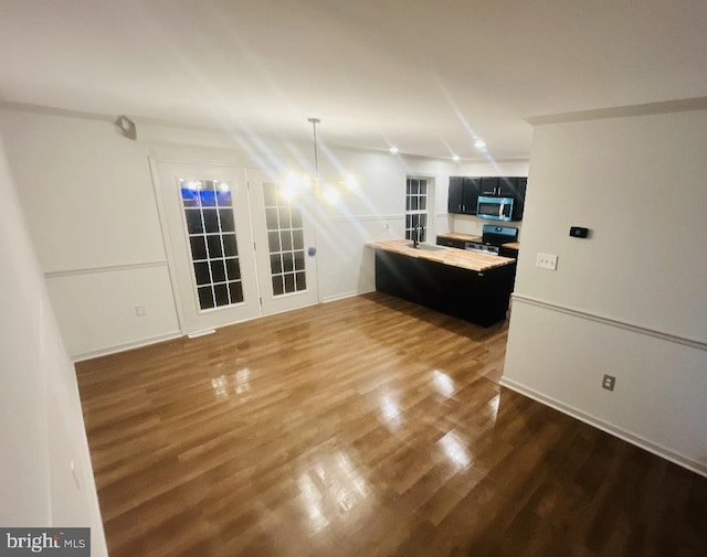 interior space featuring appliances with stainless steel finishes, sink, and hardwood / wood-style floors