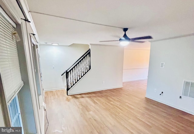 unfurnished room with ceiling fan and light hardwood / wood-style floors