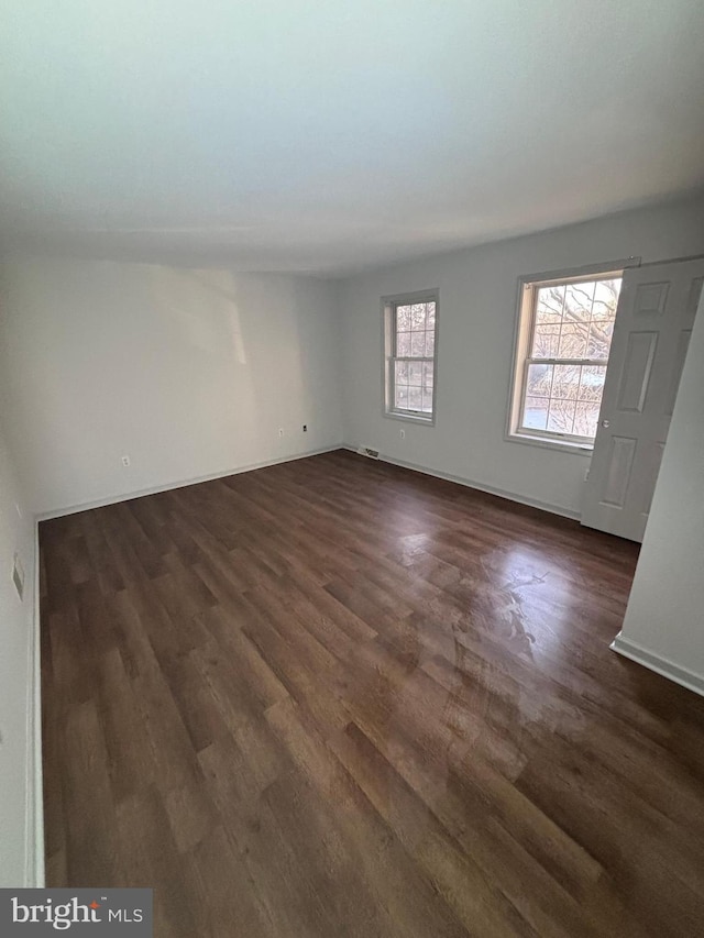 unfurnished room with dark hardwood / wood-style floors